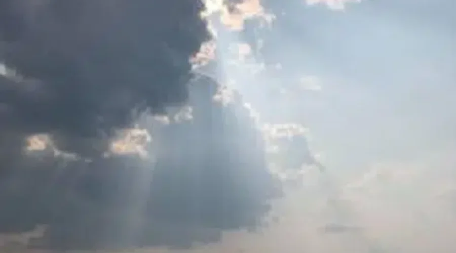 Sunshine Peeking Through The Clouds Over The Lake